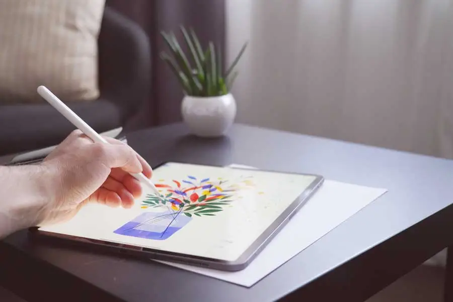 digital illustrator creates a drawing on a ipad