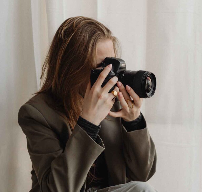 A women taking a photograph with a camera